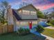 Charming home featuring a red front door, large windows, and well-maintained landscaping at 103 W Maple St, Davenport, FL 33837