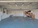 Two car garage with painted floor, shelving, and good lighting at 103 W Maple St, Davenport, FL 33837