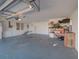 Two car garage with painted floor, shelving, and ample storage space at 103 W Maple St, Davenport, FL 33837