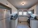 Well-appointed kitchen featuring stainless steel appliances, white cabinets, and granite countertops at 103 W Maple St, Davenport, FL 33837