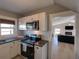 Updated kitchen with stainless steel appliances, granite countertops, and white cabinets at 103 W Maple St, Davenport, FL 33837
