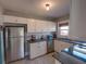 Bright kitchen with granite countertops, stainless steel appliances, and classic white cabinetry at 103 W Maple St, Davenport, FL 33837
