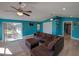 Relaxing living room with a large sectional sofa and a sliding glass door leading to the lanai at 103 W Maple St, Davenport, FL 33837