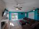 Inviting living room with sliding glass doors, vaulted ceilings, and a cozy brick fireplace at 103 W Maple St, Davenport, FL 33837