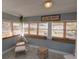 Relaxing sunroom features neutral paint, multiple windows with bamboo blinds, and wicker furniture at 103 W Maple St, Davenport, FL 33837