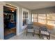 Cozy sunroom features comfortable seating, large windows, and views into other rooms at 103 W Maple St, Davenport, FL 33837