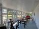 Sunroom features large windows, a brick wall, and an exercise bike perfect for recreation or relaxation at 103 W Maple St, Davenport, FL 33837