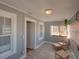 Bright sunroom with beadboard ceiling, a comfortable chair, and natural light at 103 W Maple St, Davenport, FL 33837