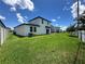 Spacious backyard with lush green grass, a patio and privacy fence at 1220 Hilltop Pl # 1220, St Cloud, FL 34772