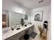 Updated bathroom features a double vanity, granite countertop, and modern decor at 1220 Hilltop Pl # 1220, St Cloud, FL 34772