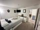 Cozy bedroom with bed, drawers, TV, and adjacent room access at 1220 Hilltop Pl # 1220, St Cloud, FL 34772