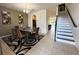 Open-concept dining room with a modern chandelier, rug and staircase at 1220 Hilltop Pl # 1220, St Cloud, FL 34772