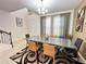 Dining room featuring a modern chandelier, large windows with curtains, and statement rug at 1220 Hilltop Pl # 1220, St Cloud, FL 34772