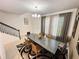 Dining room featuring a modern chandelier, large windows with curtains, and statement rug at 1220 Hilltop Pl # 1220, St Cloud, FL 34772