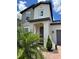 Home's front entrance with neutral paint, a gray door and manicured plants at 1220 Hilltop Pl # 1220, St Cloud, FL 34772