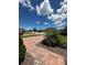 Home's front yard has a brick driveway and beautiful manicured landscaping at 1220 Hilltop Pl # 1220, St Cloud, FL 34772