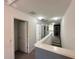 Bright hallway features neutral walls and carpeting, multiple doorways, and recessed lighting for a clean, modern aesthetic at 1220 Hilltop Pl # 1220, St Cloud, FL 34772