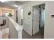 Upstairs hallway with white doors leads to a bathroom with a large vanity at 1220 Hilltop Pl # 1220, St Cloud, FL 34772