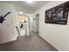 Upstairs hallway features neutral carpet, white walls, and decorative artwork at 1220 Hilltop Pl # 1220, St Cloud, FL 34772