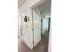 Hallway with white doors and white trim leads to bathroom and bedroom at 1220 Hilltop Pl # 1220, St Cloud, FL 34772