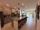 Spacious kitchen with granite countertops, stainless steel appliances, and a breakfast bar at 1220 Hilltop Pl # 1220, St Cloud, FL 34772