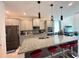 Kitchen featuring granite countertops, stainless steel appliances, and breakfast bar with red stools at 1220 Hilltop Pl # 1220, St Cloud, FL 34772