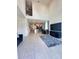Open concept living room featuring soaring ceilings, tile flooring, and a seamless flow to kitchen at 1220 Hilltop Pl # 1220, St Cloud, FL 34772