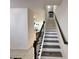 Beautiful staircase with wooden banister leading to the upper level at 1220 Hilltop Pl # 1220, St Cloud, FL 34772