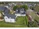 Aerial view of the property showcasing the lush backyard, solar panels, and detached garage at 1251 Aquila Loop, Celebration, FL 34747