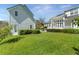 Expansive backyard with manicured lawn and lush landscaping offers privacy and space for outdoor activities at 1251 Aquila Loop, Celebration, FL 34747