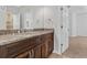Bathroom featuring a double sink vanity with granite countertop and dark wood cabinets at 1251 Aquila Loop, Celebration, FL 34747