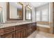 Bathroom with double sink vanity, granite countertops, and tile flooring at 1251 Aquila Loop, Celebration, FL 34747