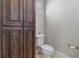 Bathroom featuring dark wood cabinets and white commode at 1251 Aquila Loop, Celebration, FL 34747