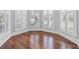 Bright room featuring hardwood floors and large bay windows with white shutters, offering natural light at 1251 Aquila Loop, Celebration, FL 34747