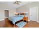 Cozy bedroom with hardwood floors, fan, and dual nightstands at 1251 Aquila Loop, Celebration, FL 34747