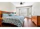 Comfortable bedroom with hardwood floors, fan, and lots of natural light at 1251 Aquila Loop, Celebration, FL 34747