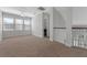 Bonus room showcases the staircase, neutral carpeting, and three bright windows at 1251 Aquila Loop, Celebration, FL 34747
