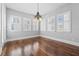 Charming dining room featuring hardwood floors, natural light from multiple windows, and a decorative chandelier at 1251 Aquila Loop, Celebration, FL 34747