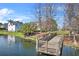Wooden dock on a tranquil lake offers serene waterfront access and adds charm to the picturesque landscape at 1251 Aquila Loop, Celebration, FL 34747