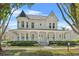 Charming two-story home with a inviting wraparound porch, turret, and manicured lawn at 1251 Aquila Loop, Celebration, FL 34747