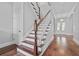 Traditional stairway with hard wood flooring, white risers and a chandelier at front entry at 1251 Aquila Loop, Celebration, FL 34747