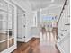 Elegant home foyer with hardwood floors, staircase, and lots of natural light from large bright windows at 1251 Aquila Loop, Celebration, FL 34747