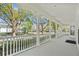 Spacious front porch with elegant white railings and columns, offering views of the street and neighborhood at 1251 Aquila Loop, Celebration, FL 34747