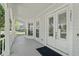 Inviting front porch with white columns, and double doors enhancing curb appeal and providing a welcoming entry at 1251 Aquila Loop, Celebration, FL 34747