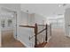 Upstairs hallway and landing with hardwood railing and view of multiple rooms at 1251 Aquila Loop, Celebration, FL 34747