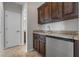 Butler's pantry with custom wood cabinets, mini fridge, and granite countertops at 1251 Aquila Loop, Celebration, FL 34747