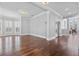 Spacious living room with hardwood floors, crown molding, with windows and a doorway leading to other rooms at 1251 Aquila Loop, Celebration, FL 34747