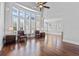 Bright, spacious living room with hardwood floors, ceiling fan, lots of natural light, and comfortable seating at 1251 Aquila Loop, Celebration, FL 34747