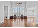 Spacious living room with hardwood floors, a ceiling fan, and large windows providing lots of natural light at 1251 Aquila Loop, Celebration, FL 34747