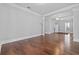 Spacious living room featuring hardwood floors, chandeliers, and large white columns, with lots of natural light at 1251 Aquila Loop, Celebration, FL 34747